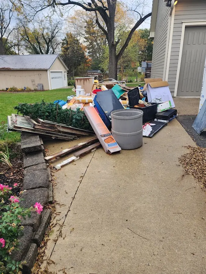 Dumpster being loaded with debris for Estate Cleanout Dumpster Rental in Clayton